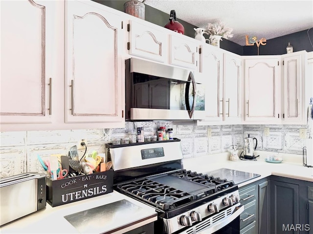 18 Sandstone Ct, Troy, IL 62294 - kitchen featuring stainless steel appliances, light countertops, white cabinets, and tasteful backsplash