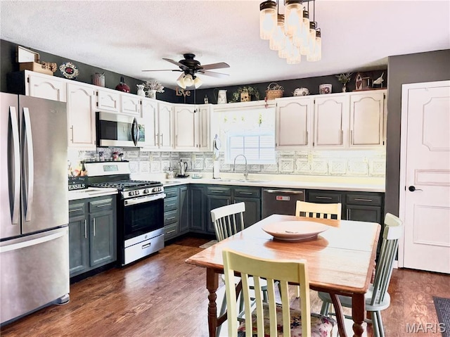 18 Sandstone Ct, Troy, IL 62294 - kitchen with appliances with stainless steel finishes, backsplash, ceiling fan, and dark wood finished floors