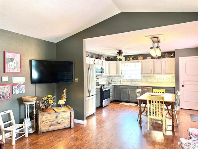 18 Sandstone Ct, Troy, IL 62294 - kitchen featuring appliances with stainless steel finishes, lofted ceiling, wood finished floors, backsplash, and ceiling fan