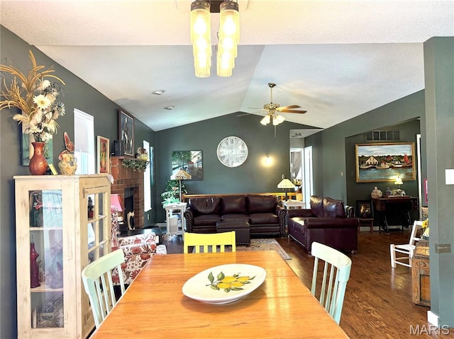 18 Sandstone Ct, Troy, IL 62294 - dining room featuring lofted ceiling, wood finished floors, ceiling fan, and a brick fireplace