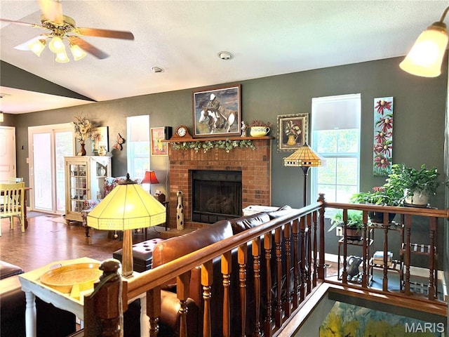 18 Sandstone Ct, Troy, IL 62294 - living area featuring a ceiling fan, a brick fireplace, vaulted ceiling, and wood finished floors