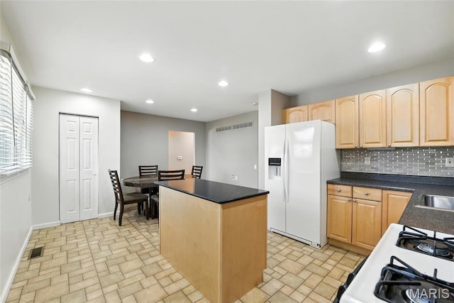 3205 Fleet Ln, Saint Charles, MO 63301 - kitchen with white fridge with ice dispenser, light brown cabinetry, a kitchen island, backsplash, and recessed lighting