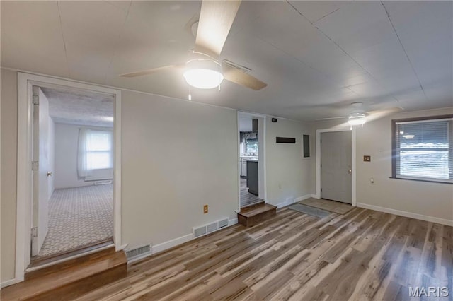 656 Sunset Farms Trl, Union, MO 63084 - spare room with a ceiling fan, wood finished floors, and stairs