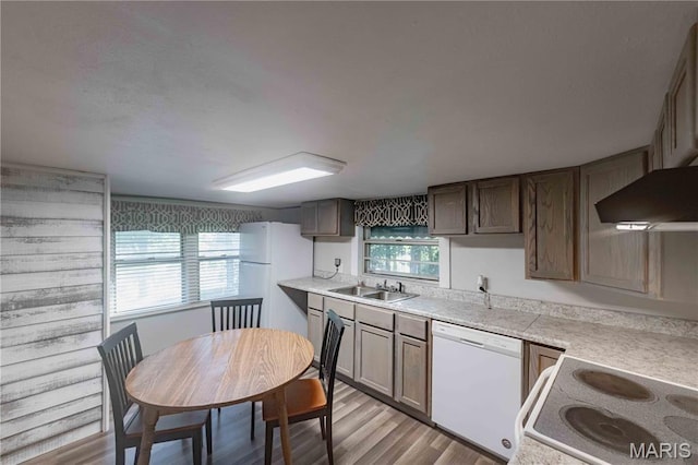 656 Sunset Farms Trl, Union, MO 63084 - kitchen featuring white appliances, light countertops, light wood finished floors, and wall chimney range hood
