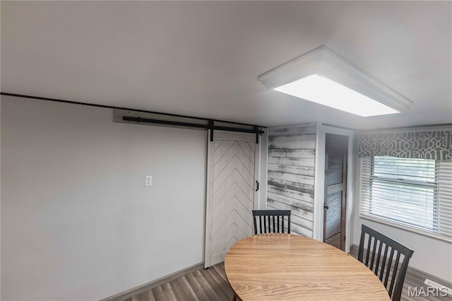 656 Sunset Farms Trl, Union, MO 63084 - dining space featuring a barn door, wood finished floors, and wood walls