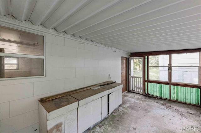 656 Sunset Farms Trl, Union, MO 63084 - unfurnished sunroom with concrete block wall and concrete flooring