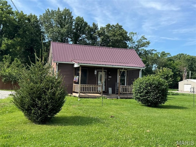 1516 W Main St, Vandalia, IL 62471 - view of front of house featuring a front yard, a porch, a metal roof, and a garage