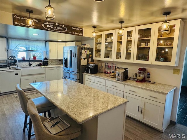 1516 W Main St, Vandalia, IL 62471 - kitchen featuring white dishwasher, high end refrigerator, a kitchen breakfast bar, white cabinets, and dark wood finished floors