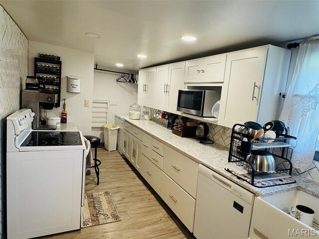 1516 W Main St, Vandalia, IL 62471 - kitchen featuring white appliances, light wood-type flooring, light countertops, white cabinetry, and recessed lighting