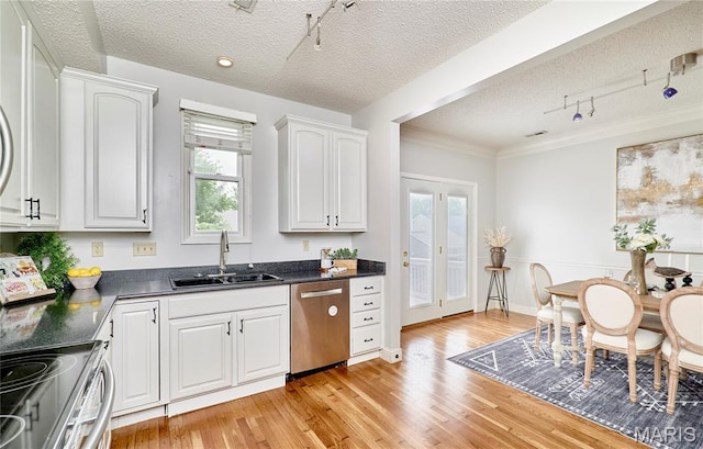 3432 Civic Green Dr, Saint Charles, MO 63301 - kitchen featuring stainless steel appliances, rail lighting, dark countertops, a textured ceiling, and light wood-style floors