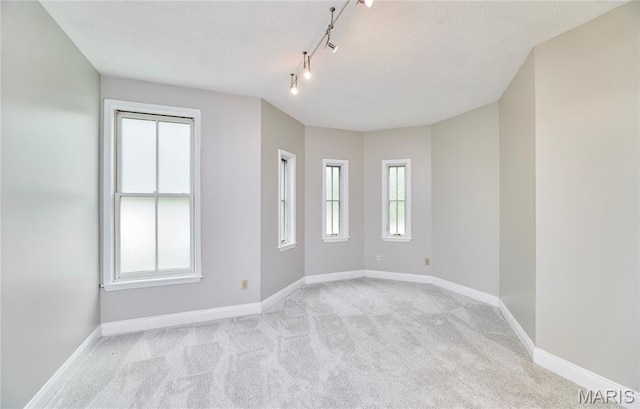 3432 Civic Green Dr, Saint Charles, MO 63301 - empty room with light carpet, track lighting, and plenty of natural light