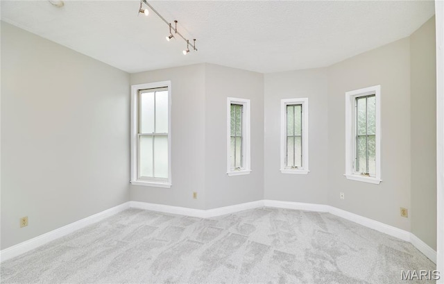 3432 Civic Green Dr, Saint Charles, MO 63301 - empty room with light colored carpet, track lighting, and a textured ceiling
