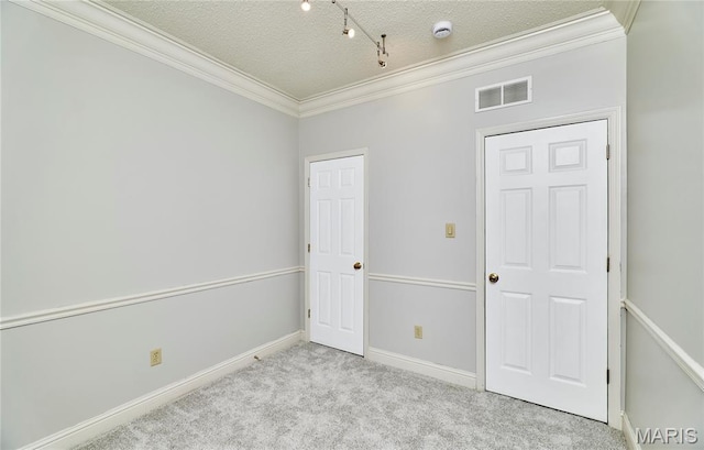 3432 Civic Green Dr, Saint Charles, MO 63301 - unfurnished bedroom featuring crown molding, carpet floors, a textured ceiling, and rail lighting
