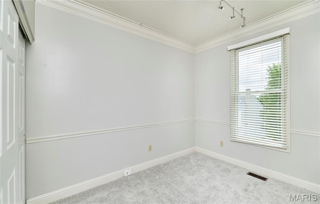 3432 Civic Green Dr, Saint Charles, MO 63301 - carpeted spare room featuring ornamental molding, rail lighting, and a textured ceiling
