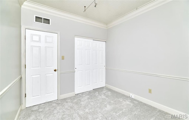 3432 Civic Green Dr, Saint Charles, MO 63301 - unfurnished bedroom featuring ornamental molding, carpet flooring, a closet, and a textured ceiling
