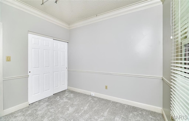 3432 Civic Green Dr, Saint Charles, MO 63301 - unfurnished bedroom featuring carpet, ornamental molding, a closet, and a textured ceiling