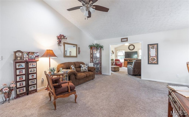 708 Chestnut Dr, Rolla, MO 65401 - carpeted living room with a ceiling fan, a textured ceiling, and vaulted ceiling