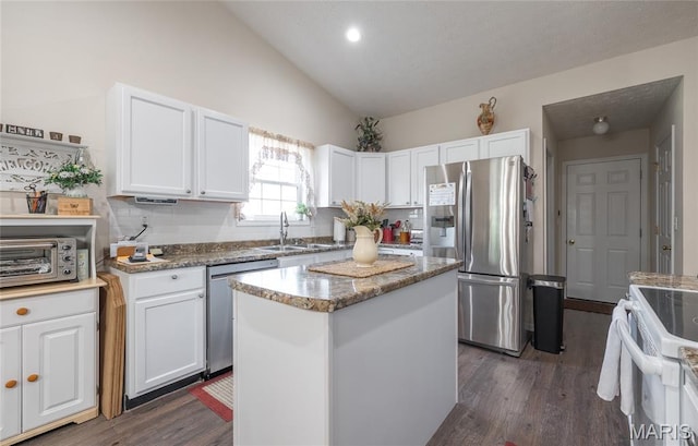 708 Chestnut Dr, Rolla, MO 65401 - kitchen with appliances with stainless steel finishes, dark wood-type flooring, white cabinets, a kitchen island, and light stone countertops
