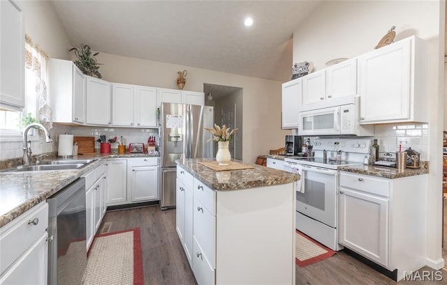708 Chestnut Dr, Rolla, MO 65401 - kitchen featuring appliances with stainless steel finishes, a kitchen island, dark wood-type flooring, white cabinetry, and lofted ceiling