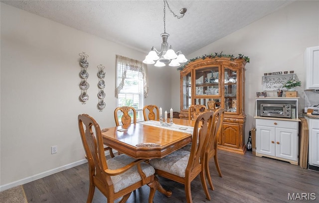 708 Chestnut Dr, Rolla, MO 65401 - dining area featuring a chandelier, dark wood-style flooring, and a textured ceiling