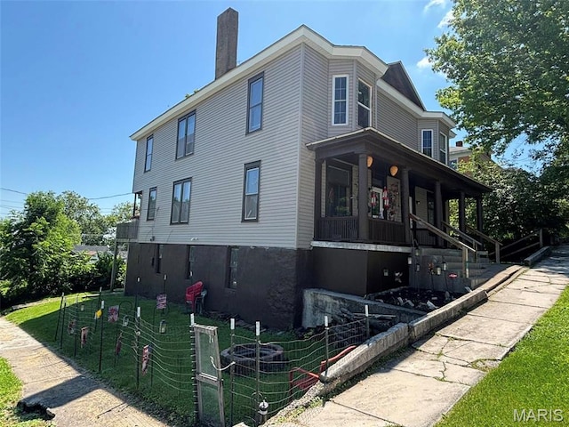 518 N 5th St Unit 518-520, Hannibal, MO 63401 - view of home's exterior with a chimney and covered porch