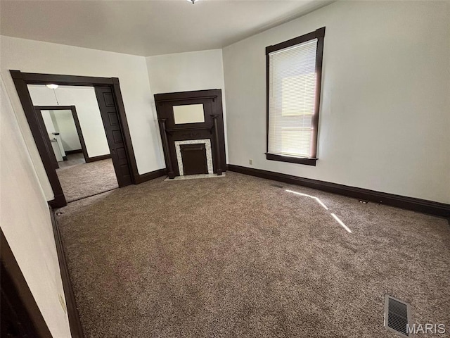 518 N 5th St Unit 518-520, Hannibal, MO 63401 - unfurnished living room with carpet and a fireplace with flush hearth
