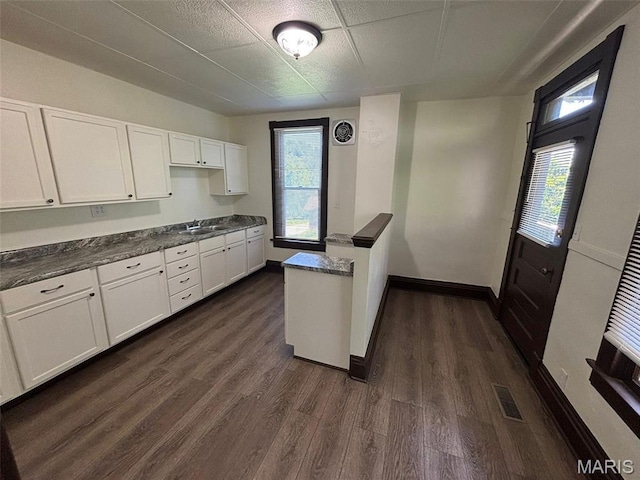 518 N 5th St Unit 518-520, Hannibal, MO 63401 - kitchen with white cabinetry, dark wood-style flooring, and dark countertops
