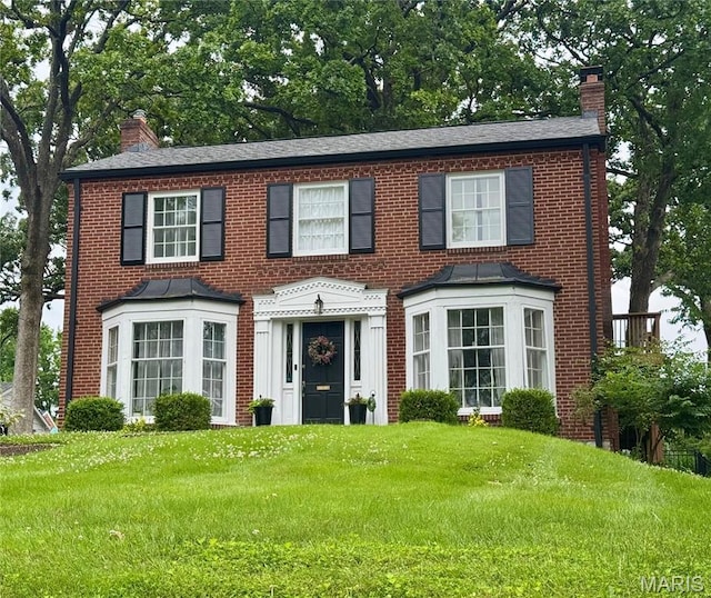 120 Roseacre Ln, Webster Groves, MO 63119 - view of front of house featuring a chimney, a front yard, and brick siding