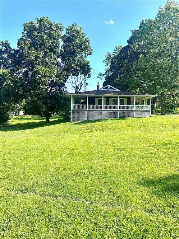 701 Alvarado, Belle, MO 65013 - back of house featuring a yard and covered porch
