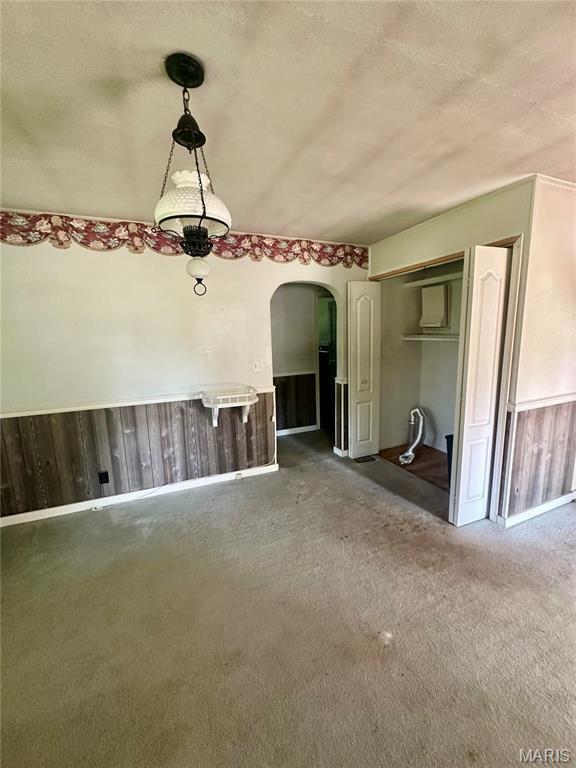 701 Alvarado, Belle, MO 65013 - unfurnished dining area with arched walkways and carpet