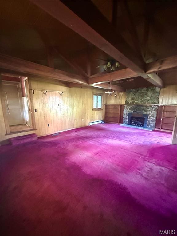 701 Alvarado, Belle, MO 65013 - unfurnished living room with a baseboard heating unit, a stone fireplace, carpet flooring, beamed ceiling, and wooden walls