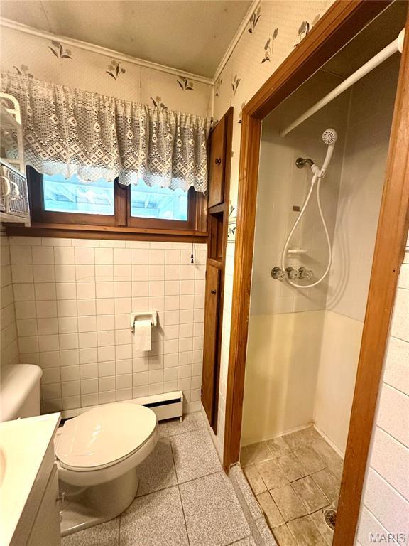 701 Alvarado, Belle, MO 65013 - bathroom featuring a shower, vanity, ornamental molding, plenty of natural light, and tile walls