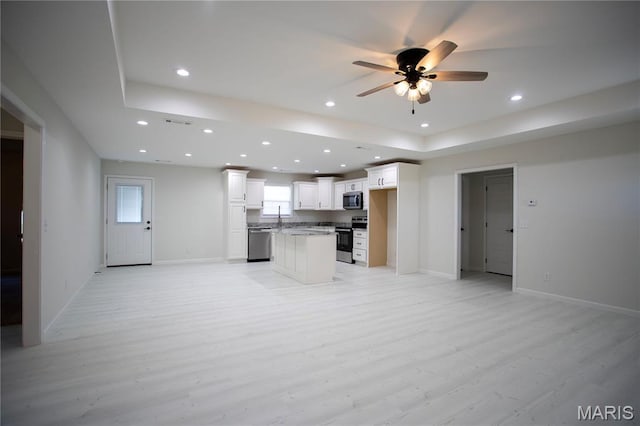 1205 Yosemite, Sikeston, MO 63801 - kitchen with appliances with stainless steel finishes, open floor plan, ceiling fan, recessed lighting, and light wood-style floors
