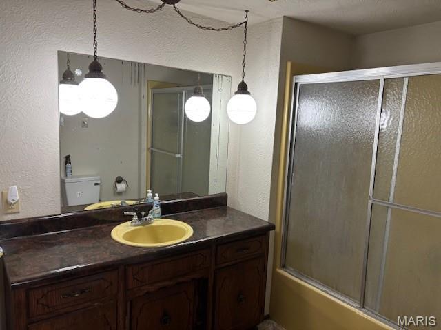 304 Taylor Ave, Park Hills, MO 63601 - bathroom featuring vanity, bath / shower combo with glass door, and a textured wall