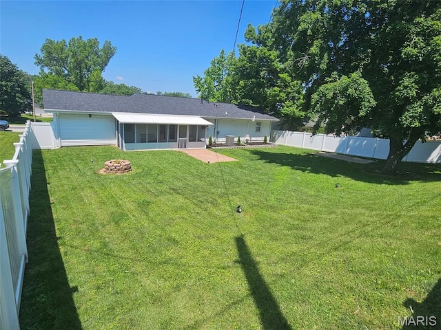 23 Hamlin Heights Dr, Hannibal, MO 63401 - rear view of house featuring a sunroom, a fire pit, a fenced backyard, and a patio