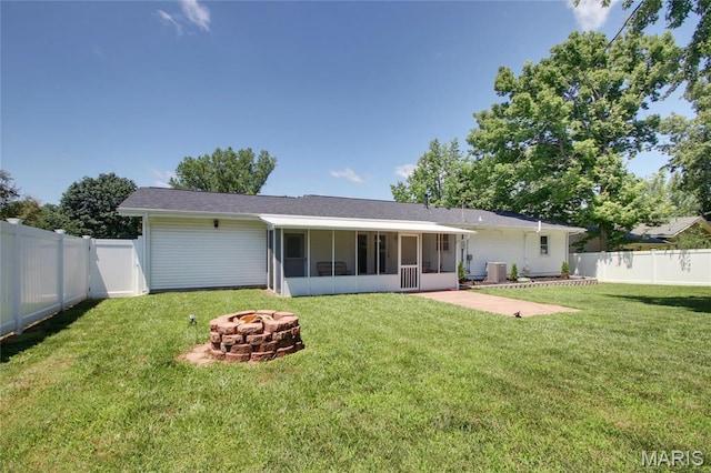 23 Hamlin Heights Dr, Hannibal, MO 63401 - back of property featuring a fire pit, a sunroom, and a fenced backyard