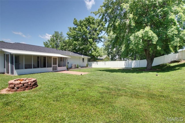 23 Hamlin Heights Dr, Hannibal, MO 63401 - fenced backyard featuring a sunroom and an outdoor fire pit