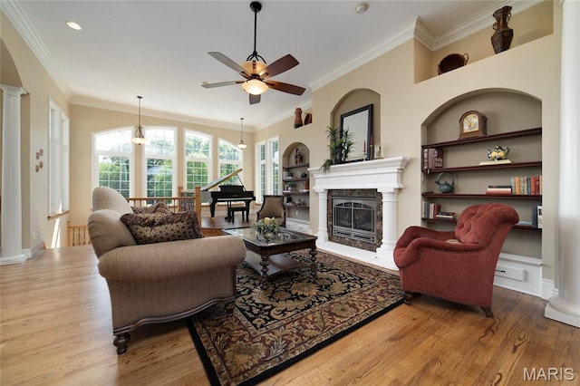 204 Logans Ct, Foristell, MO 63348 - living room featuring ceiling fan, wood finished floors, a high end fireplace, built in features, and ornamental molding