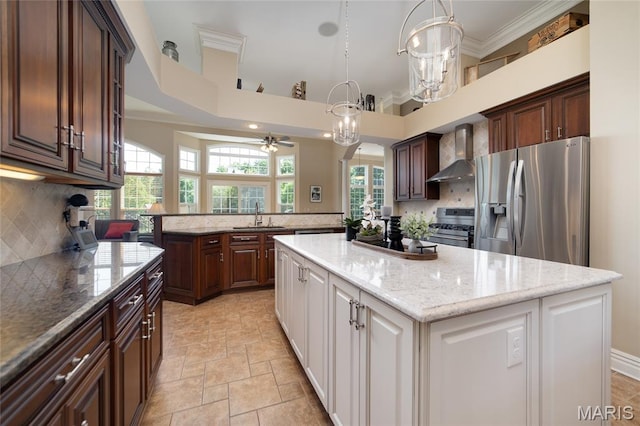 204 Logans Ct, Foristell, MO 63348 - kitchen featuring wall chimney exhaust hood, stainless steel appliances, a kitchen island, a ceiling fan, and white cabinetry