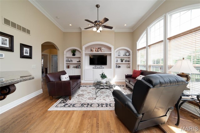 204 Logans Ct, Foristell, MO 63348 - living room featuring built in shelves, a ceiling fan, arched walkways, light wood-type flooring, and recessed lighting