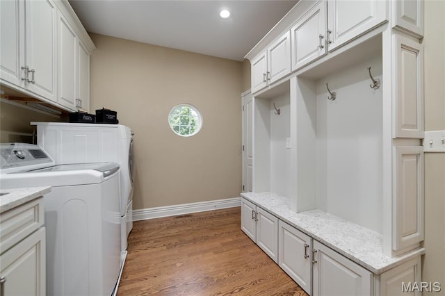 204 Logans Ct, Foristell, MO 63348 - laundry area with washing machine and clothes dryer, cabinet space, light wood-style floors, and recessed lighting
