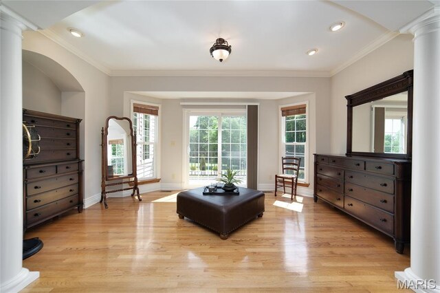 204 Logans Ct, Foristell, MO 63348 - living area with light wood-style floors, decorative columns, crown molding, recessed lighting, and arched walkways