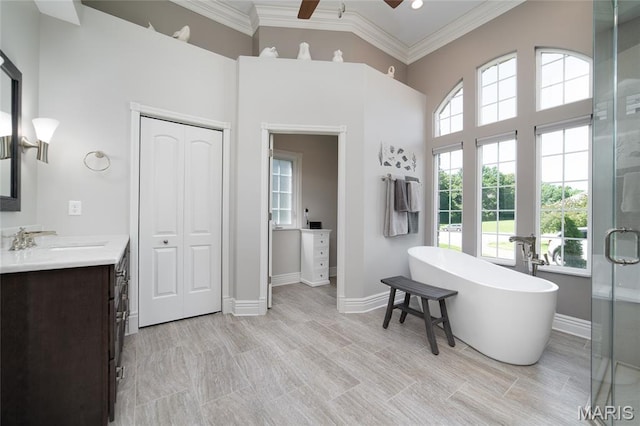 204 Logans Ct, Foristell, MO 63348 - bathroom featuring vanity, ceiling fan, crown molding, a freestanding tub, and a towering ceiling