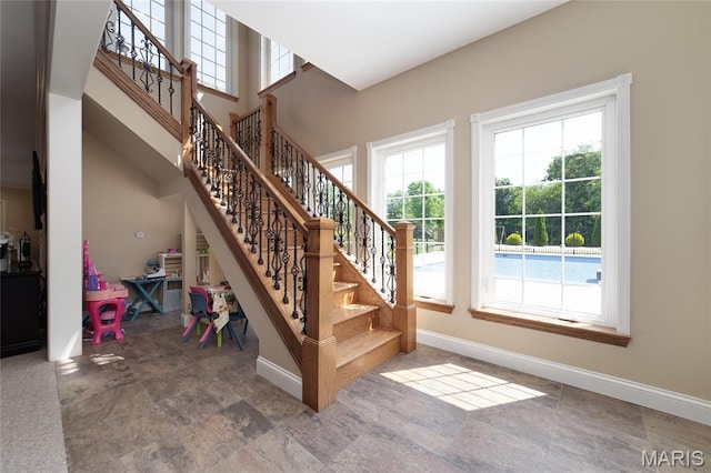 204 Logans Ct, Foristell, MO 63348 - stairway with healthy amount of natural light and stone finish flooring
