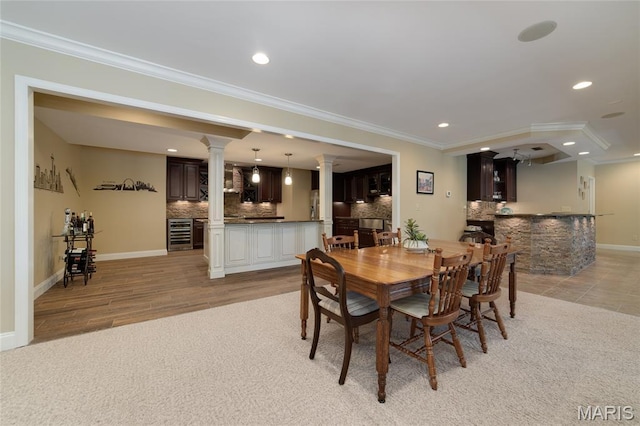 204 Logans Ct, Foristell, MO 63348 - dining room with ornate columns, wine cooler, recessed lighting, crown molding, and bar area