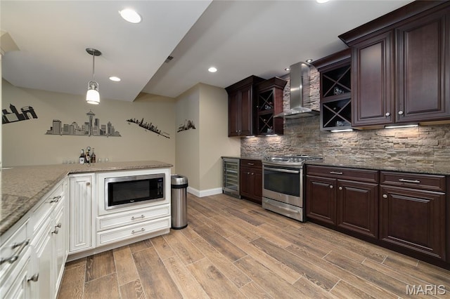 204 Logans Ct, Foristell, MO 63348 - kitchen featuring wall chimney exhaust hood, stainless steel appliances, beverage cooler, decorative backsplash, and recessed lighting