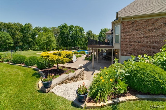 204 Logans Ct, Foristell, MO 63348 - view of green lawn with a patio, an outdoor pool, and a wooden deck