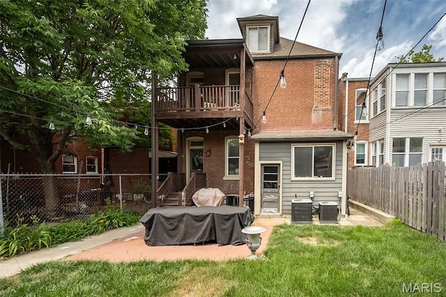 3822 Humphrey St, Saint Louis, MO 63116 - rear view of house with a balcony, a fenced backyard, brick siding, and a patio area