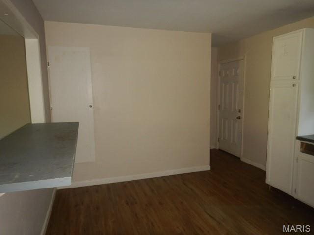 273 Buddie Ave, Saint Louis, MO 63135 - unfurnished dining area with dark wood finished floors and baseboards