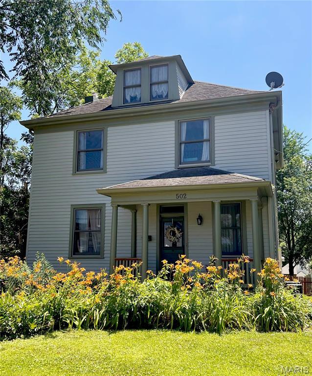 502 W 5th St, Washington, MO 63090 - traditional style home featuring a front lawn and a porch